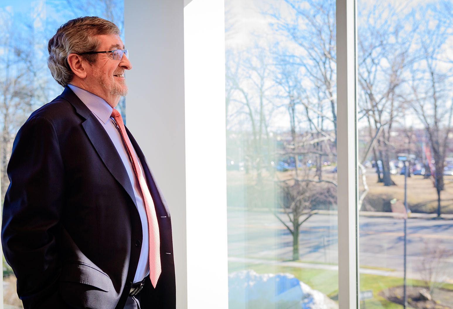 Michael Dowling, President and CEO looks out into the distance with a smile on his face